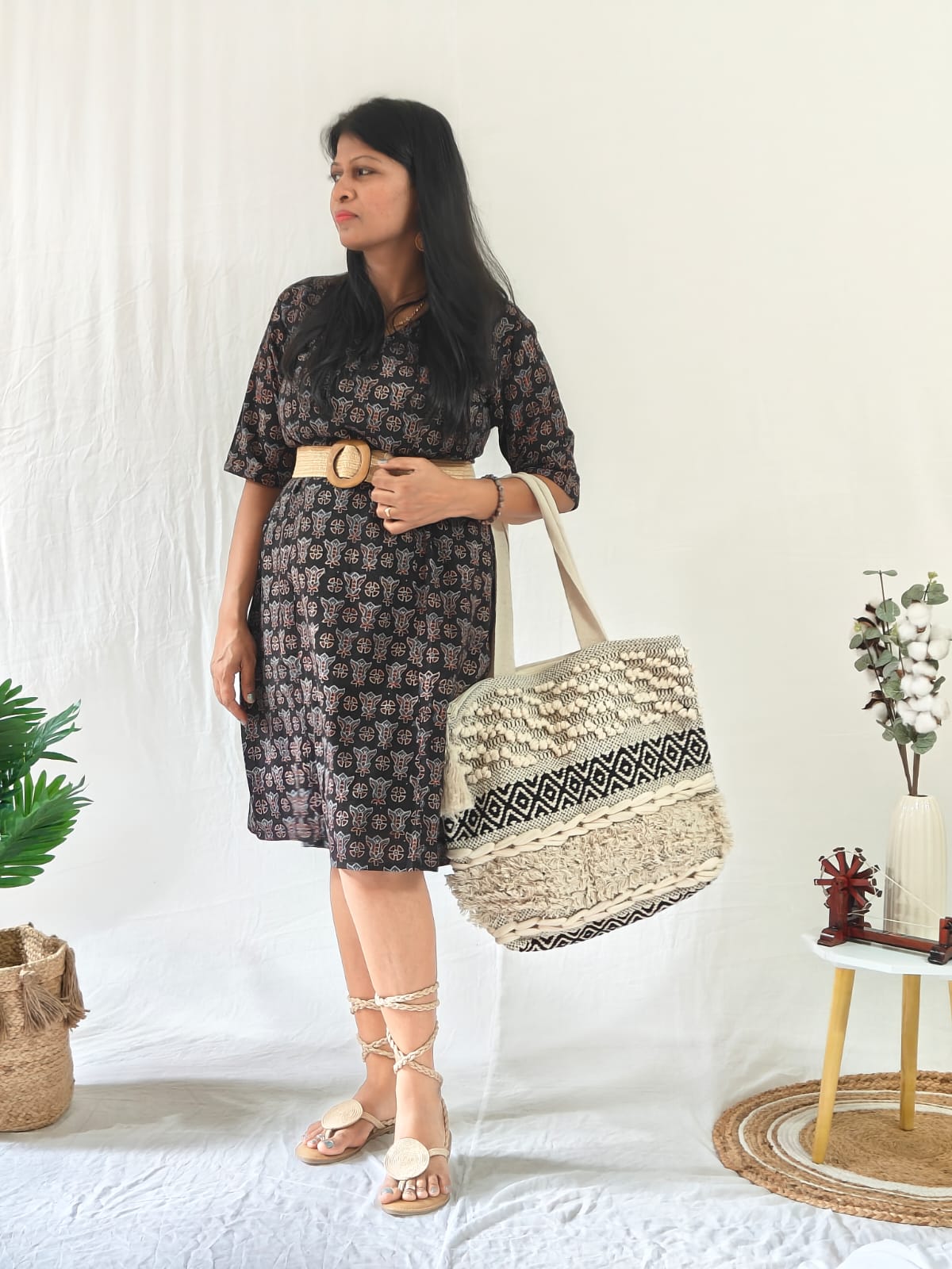 Black Ajrakh shift dress with pockets, boho accessories, belt, bag, and tie-up flat sandals.