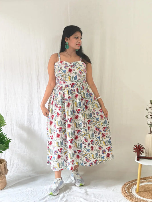 Front view of white Sanganeri block print spaghetti dress styled in a casual look.