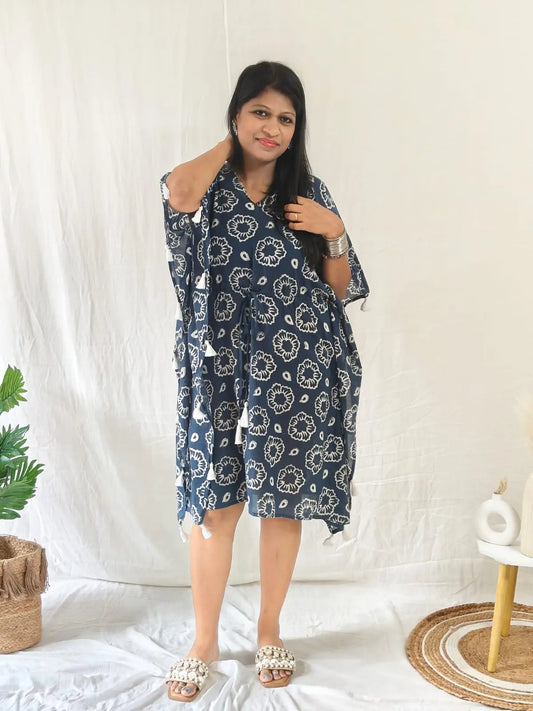Front view of blue block print kaftan with tassels, styled for beach with seashell flats and jewellery.
Front view of blue block print kaftan with tassels, styled for beach with seashell flats and jewellery.
