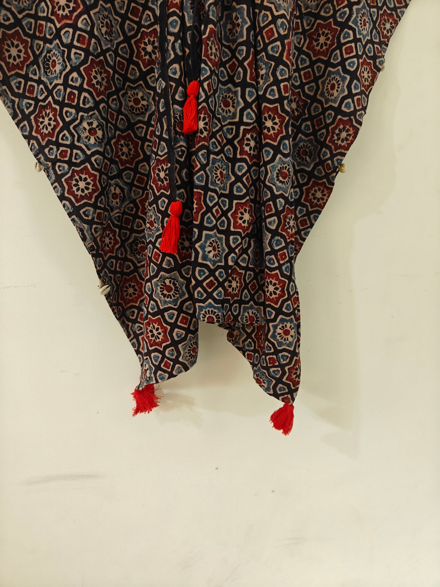 Close-up of Kaari Ajrakh Blockprint Kaftan showing tassel detailing.