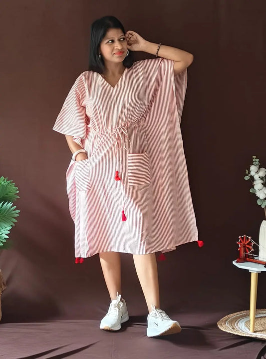 Front view of red striped kaftan styled in a casual look.