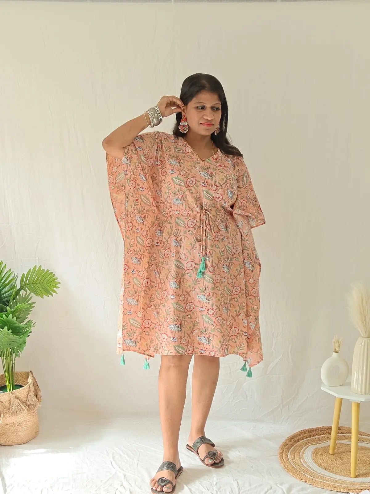 Peach block-printed kaftan styled festively with oxidised earrings, bangles, and flat footwear
