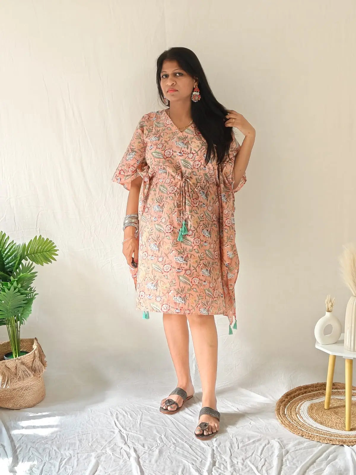 Peach block-printed kaftan styled festively with oxidised earrings, bangles, and flat footwear