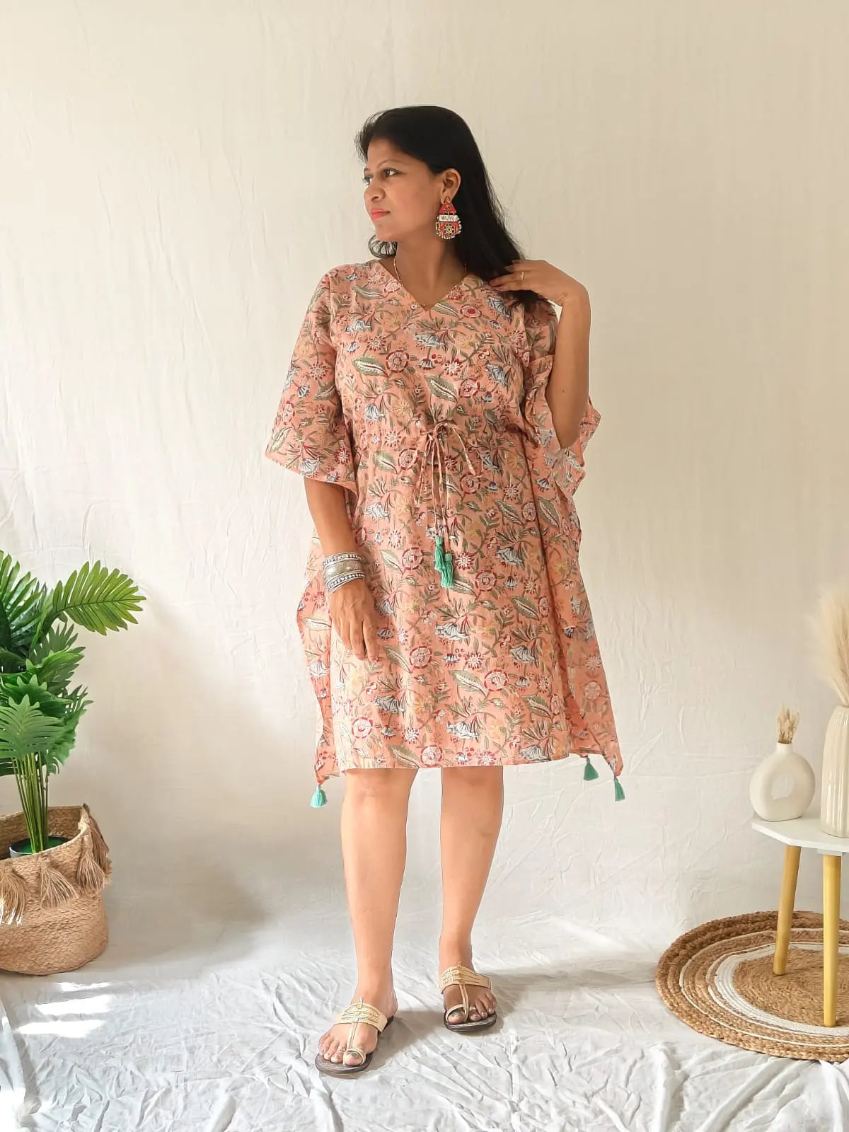Peach block-printed kaftan paired with oxidised earrings, bangles, and traditional Kolhapuri flats