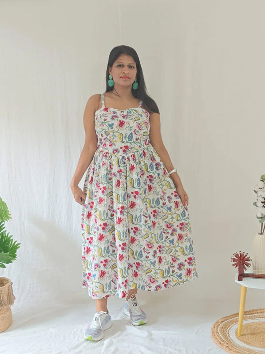 Front view of white Sanganeri block print spaghetti dress styled in a casual look.