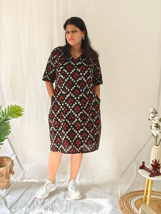 Front view Black ikkat dress with sneakers and minimal jewellery.