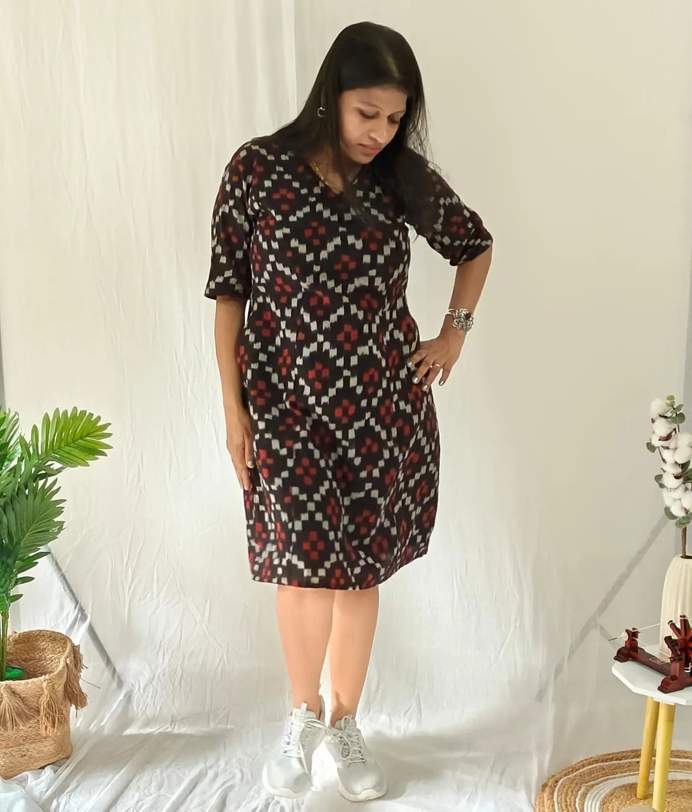 Front view Black ikkat dress with sneakers and minimal jewellery.