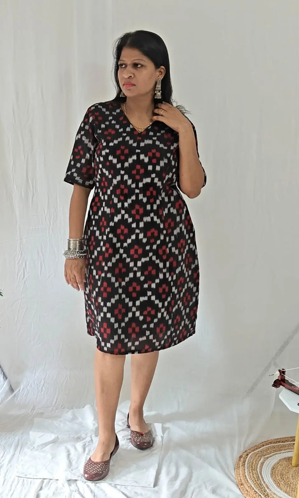 Front view Black ikkat dress with oxidised jewellery and jooti.