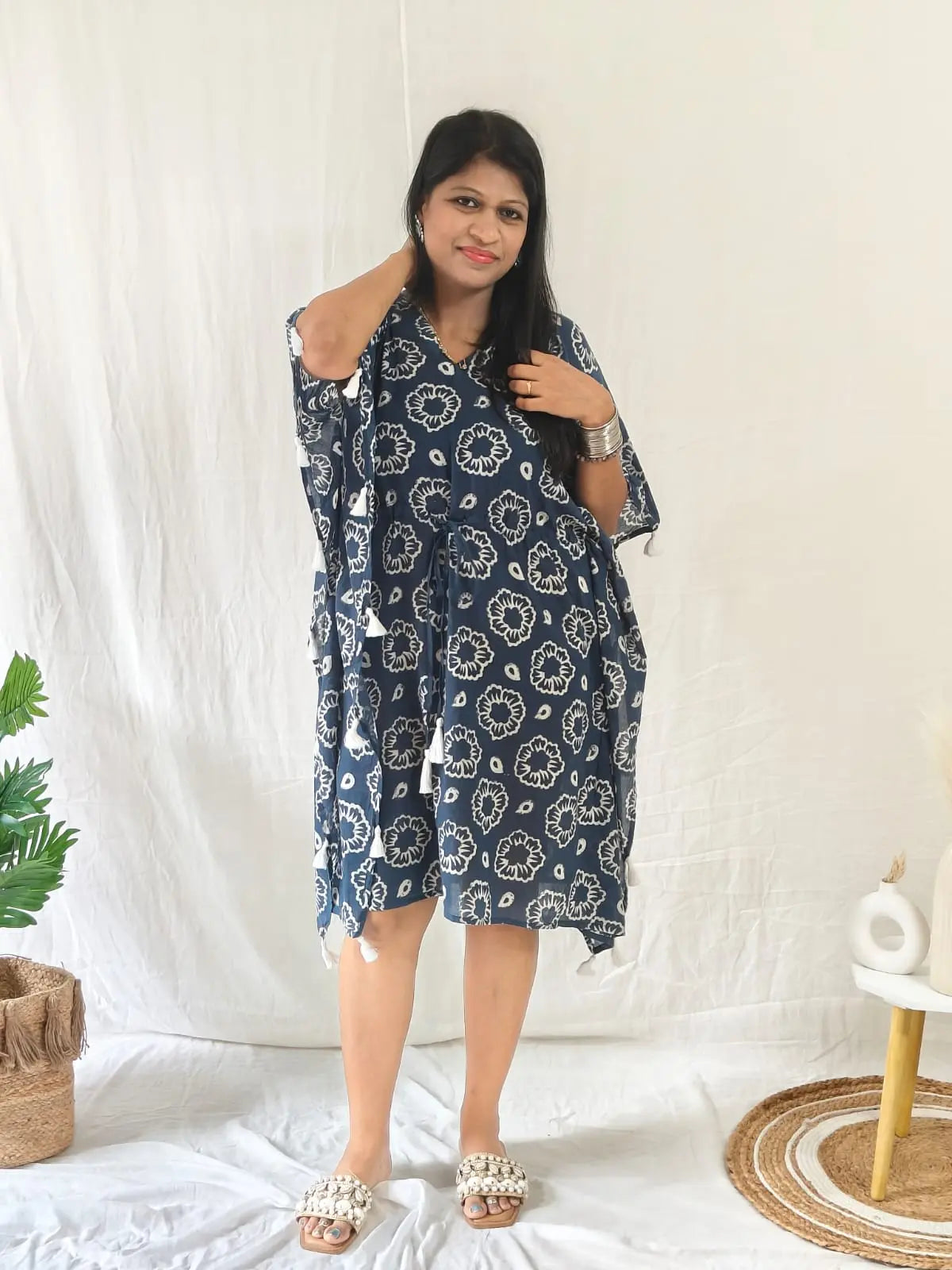 Front view of blue block print kaftan with tassels, styled for beach with seashell flats and jewellery.











Front view of blue block print kaftan with tassels, styled for beach with seashell flats and jewellery.



