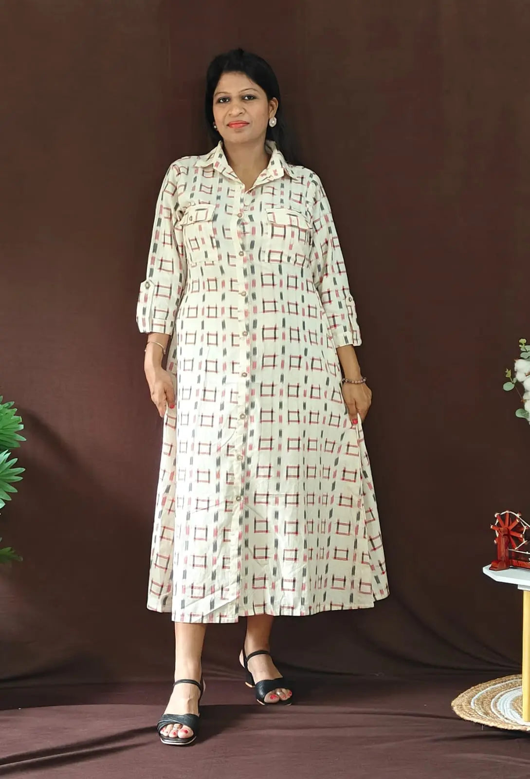 Shirt dress front view with button-down design and collar detailing.