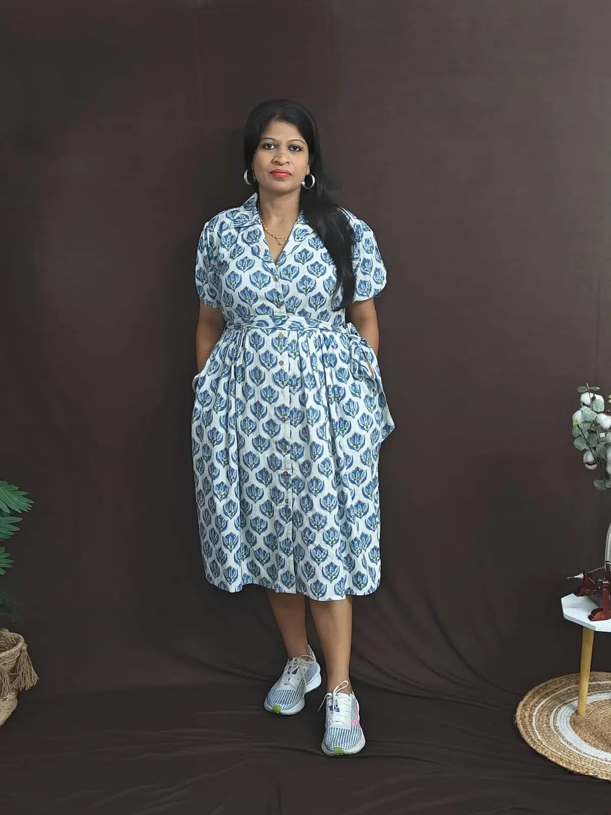 White cotton dress with blue blockprint, notched collar, button opening, and pockets on both sides