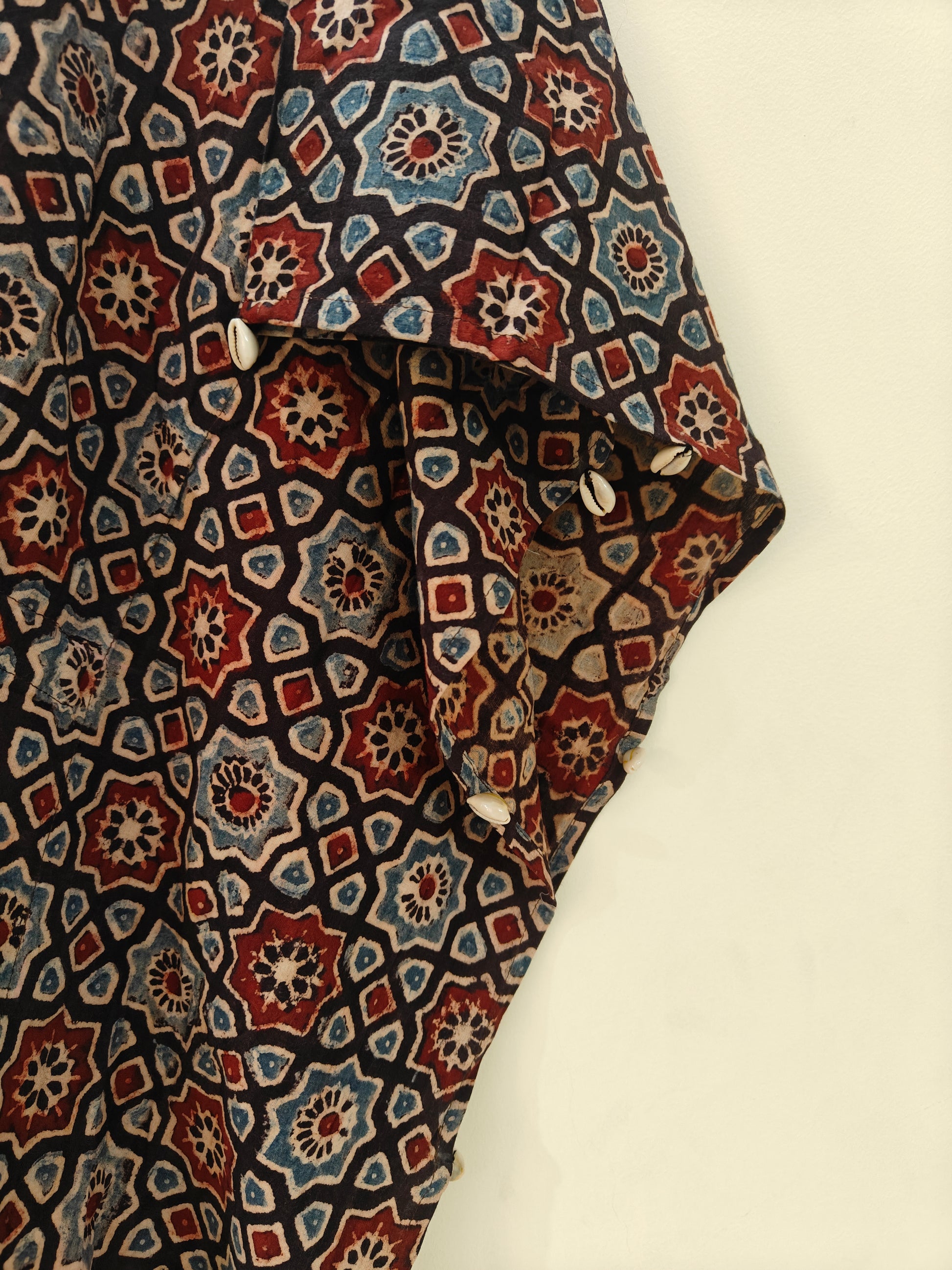 Close-up of Kaari Ajrakh Blockprint Kaftan showing shell detailing along seams.