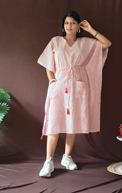Front view of red striped kaftan styled in a casual look.