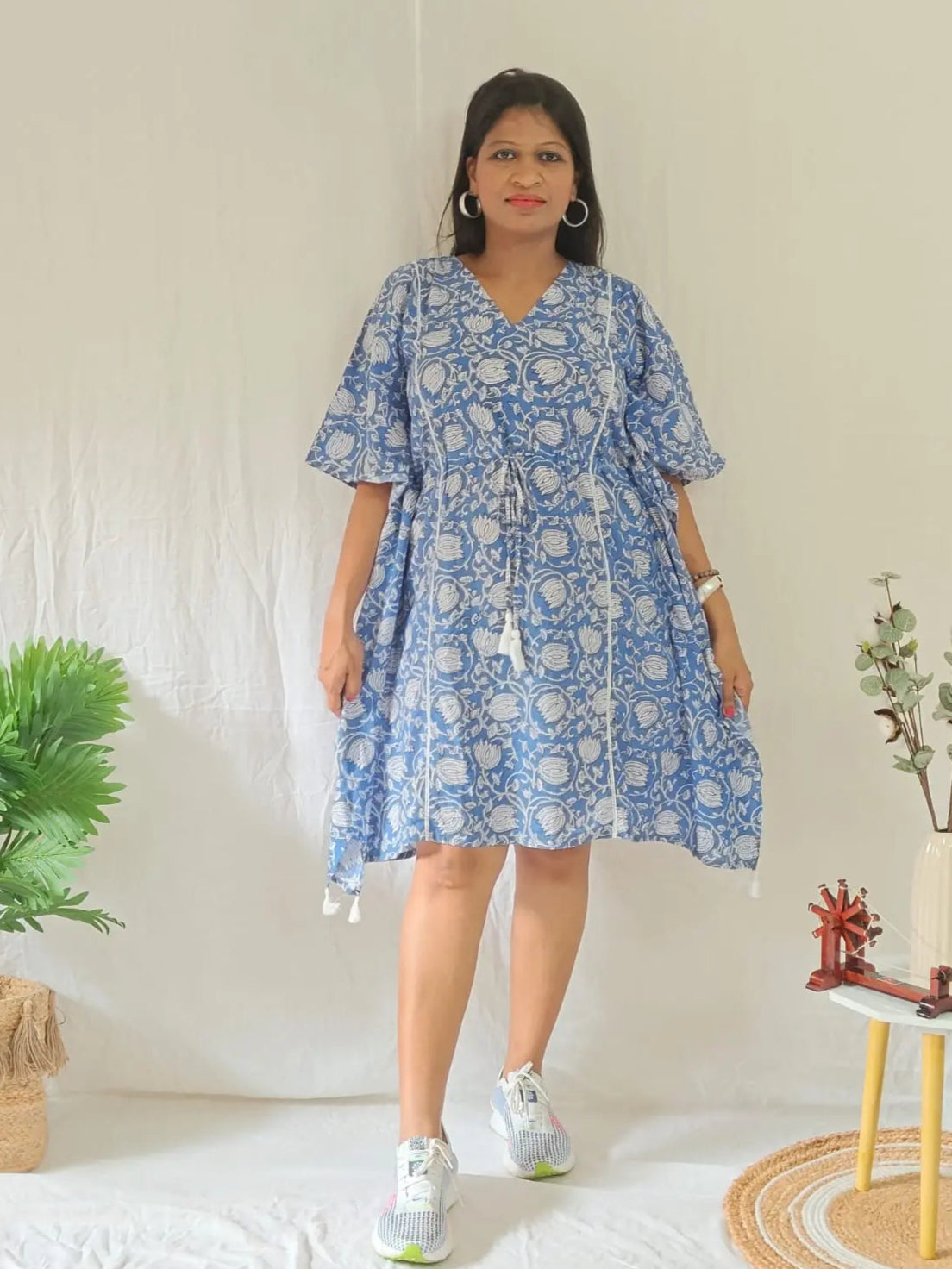 Front view of blue block print kaftan styled in a casual look.