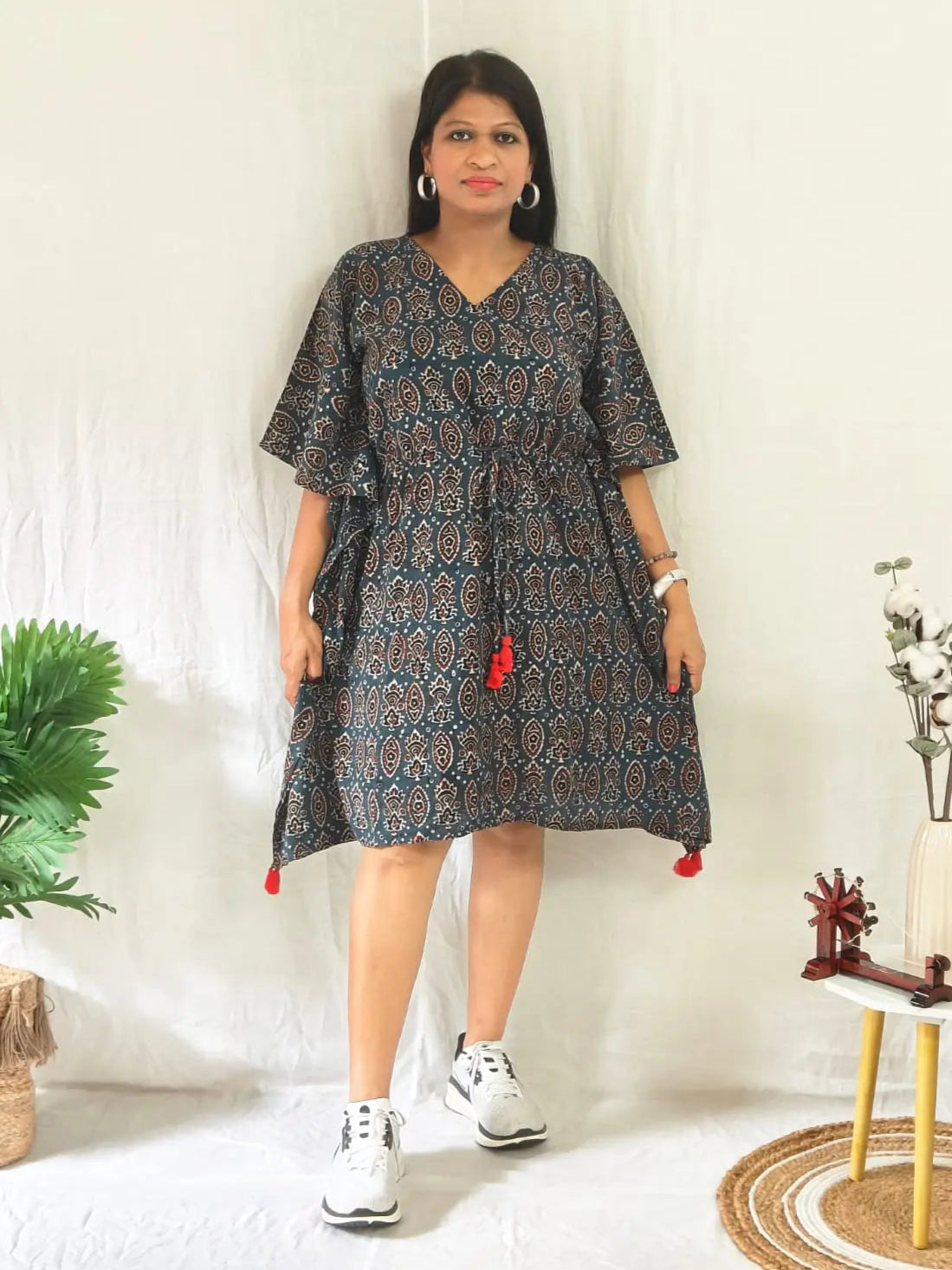 Front view of blue ajrakh block print kaftan styled casually with shoes.