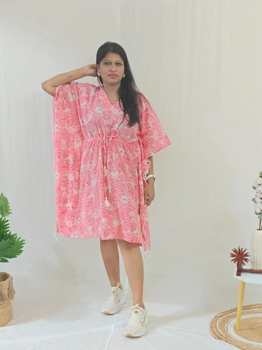 Front view of pink floral kaftan styled in a casual look.