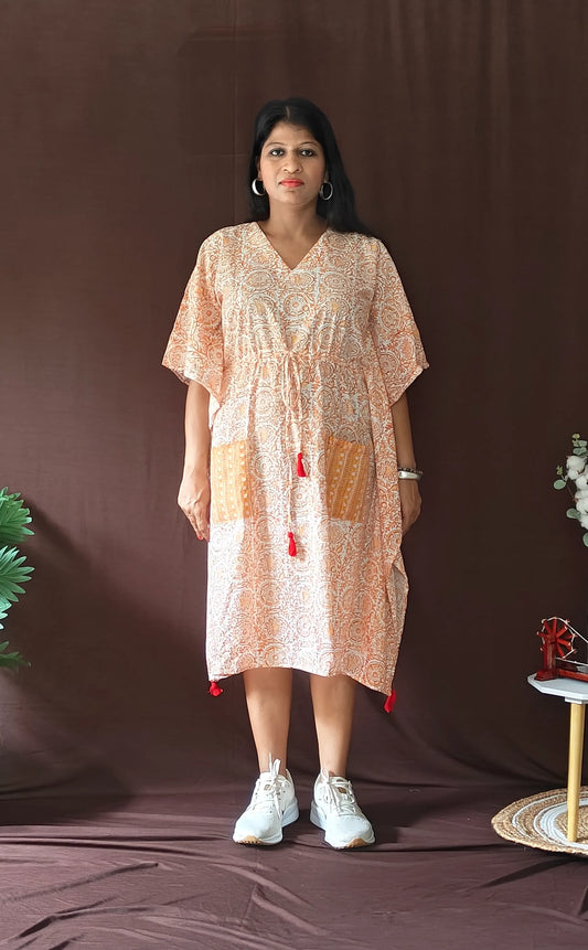Front view of orange Sanganeri block print kaftan styled in a casual look.