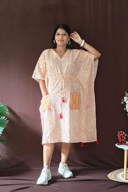 Front view of orange Sanganeri block print kaftan styled in a casual look.