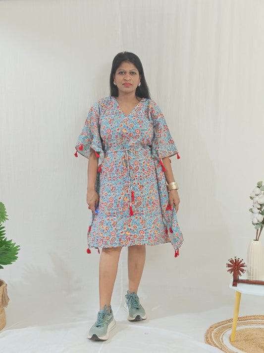 Front look of sea green kaftan featuring tassel accents, styled in a casual look.