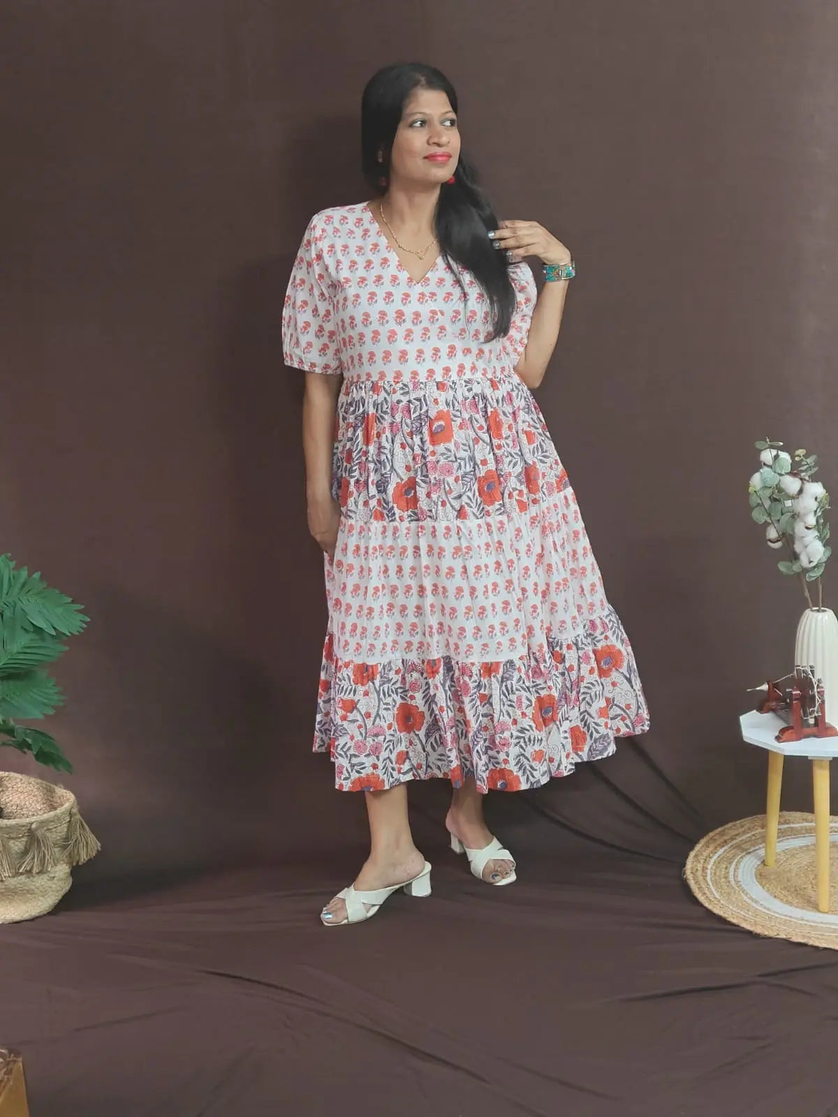 Model wearing Palasha White Dress in size XL – white tiered dress with orange artisan prints